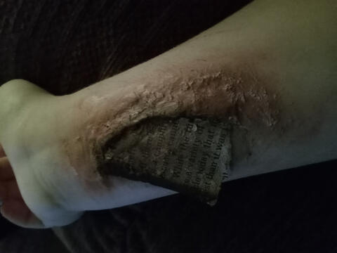 An image of sfx makeup. Paper burnt into my forearm.